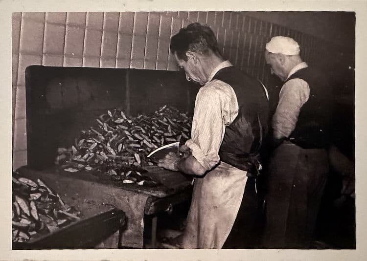 Here he is (the first on the left) focused on cutting biscuits in a photo from the mid-1950s